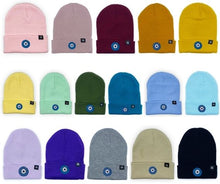 Load image into Gallery viewer, Blue Evil Eye embroidered on multiple acrylic beanies, with an RA Attire woven logo label. Group image of all sixteen colours available. Featured on white background image.