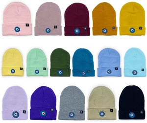Blue Evil Eye embroidered on multiple acrylic beanies, with an RA Attire woven logo label. Group image of all sixteen colours available. Featured on white background image.