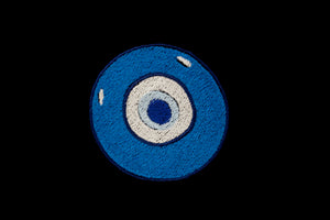 Embroidered Blue Evil Eye. Featured on a black background.