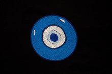 Load image into Gallery viewer, Embroidered blue evil eye. Featured on a black backrgound.