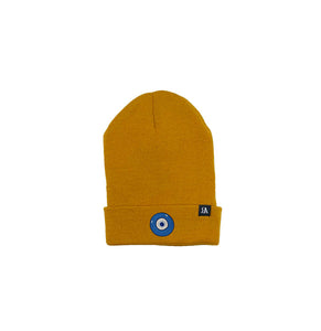 Blue Evil Eye embroidered on a burnt orange acrylic beanie, with an RA Attire woven logo label. Featured on white background image.