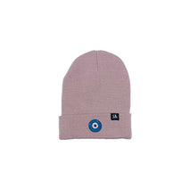 Load image into Gallery viewer, Blue Evil Eye embroidered on a dusty rose acrylic beanie, with an RA Attire woven logo label. Featured on white background image.