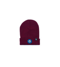 Load image into Gallery viewer, Blue Evil Eye embroidered on a burgundy acrylic beanie, with an RA Attire woven logo label. Featured on white background image.