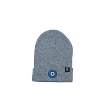 Load image into Gallery viewer, Blue Evil Eye embroidered on a grey acrylic beanie, with an RA Attire woven logo label. Featured on white background image.