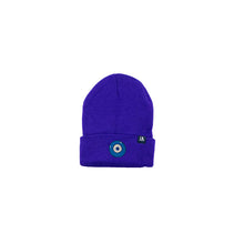 Load image into Gallery viewer, Blue Evil Eye embroidered on a dark purple acrylic beanie, with an RA Attire woven logo label. Featured on white background image.