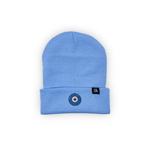 Blue Evil Eye embroidered on a periwinkle blue acrylic beanie, with an RA Attire woven logo label. Featured on white background image.
