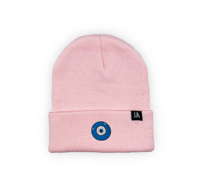 Blue Evil Eye embroidered on a pink acrylic beanie, with an RA Attire woven logo label. Featured on white background image.